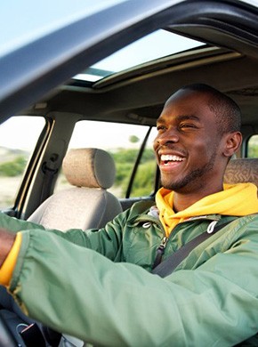 Man smiles while driving