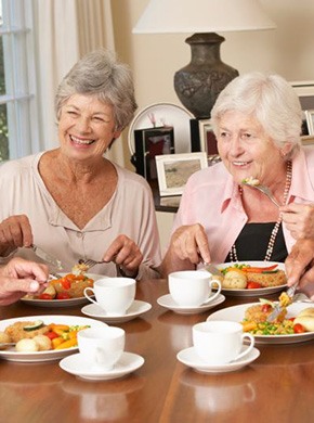 Group of older friends enjoying a meal together