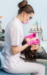 a patient undergoing a dental checkup and cleaning