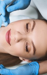 a woman holding her jaw due to pain